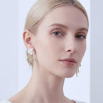 Close-up of a woman wearing White Rose Bow Drop Earrings