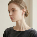 Woman wearing Silver Crystal Cross Hoop Earrings